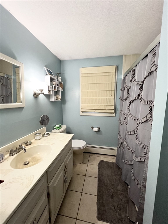 107 Enfield Street Springfield, MA 01151 - Photo 12 of 20 a spacious bathroom with a sink and a mirror