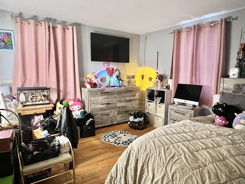 107 Enfield Street Springfield, MA 01151 - Photo 7 of 20 a bedroom with a bed a flat screen tv and a couch