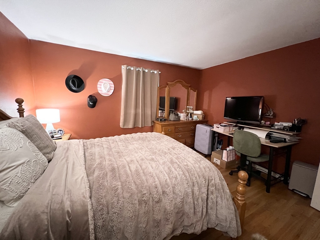 107 Enfield Street Springfield, MA 01151 - Photo 10 of 20 a bed room with a bed and a television