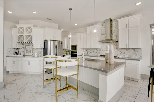 a kitchen with stainless steel appliances kitchen island granite countertop a sink and cabinets