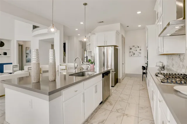 a large kitchen with lots of counter space and windows