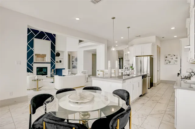 a kitchen with stainless steel appliances granite countertop a sink and a refrigerator