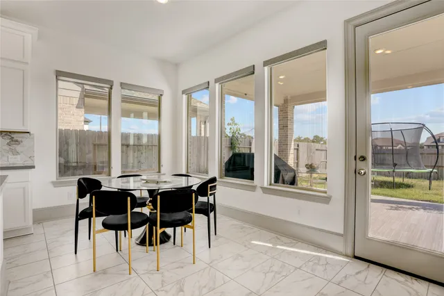 a kitchen with a dining table chairs sink and microwave