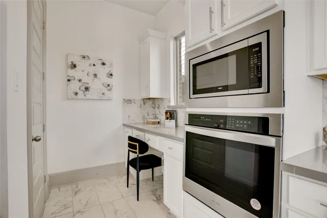 a dining room with furniture and large windows