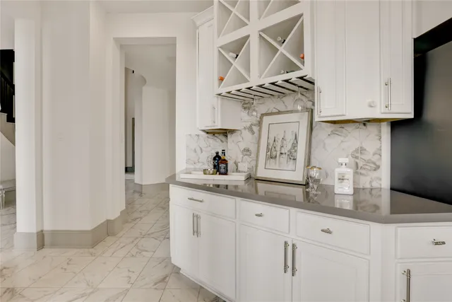 a kitchen with stainless steel appliances granite countertop white cabinets and a sink