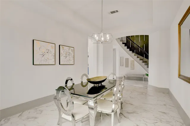 a dining room with furniture and a chandelier