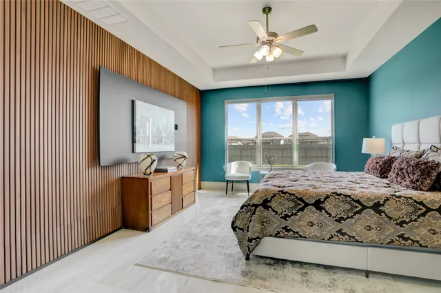 a bed room with a bed and a large window