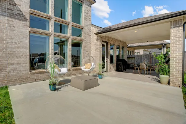 a view of a yard in front of a house with a large tree
