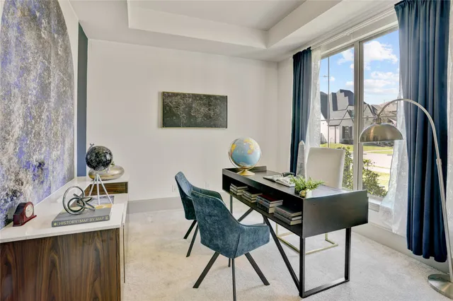 a view of a workspace with furniture and a window