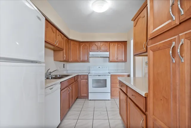 a kitchen with a stove top oven sink and cabinets