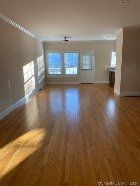 105 Lantern Court, Unit 105 Clinton, CT 06413 - Photo 4 of 6 wooden floor in an empty room with a window