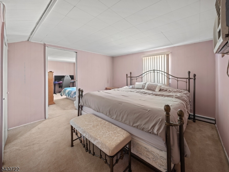 544 Goffle Hill Road Hawthorne, NJ 07506 - Photo 13 of 26 a bedroom with a bed and a mirror