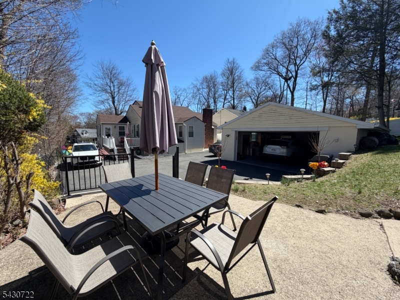 544 Goffle Hill Road Hawthorne, NJ 07506 - Photo 24 of 26 a view of backyard with seating space and trees