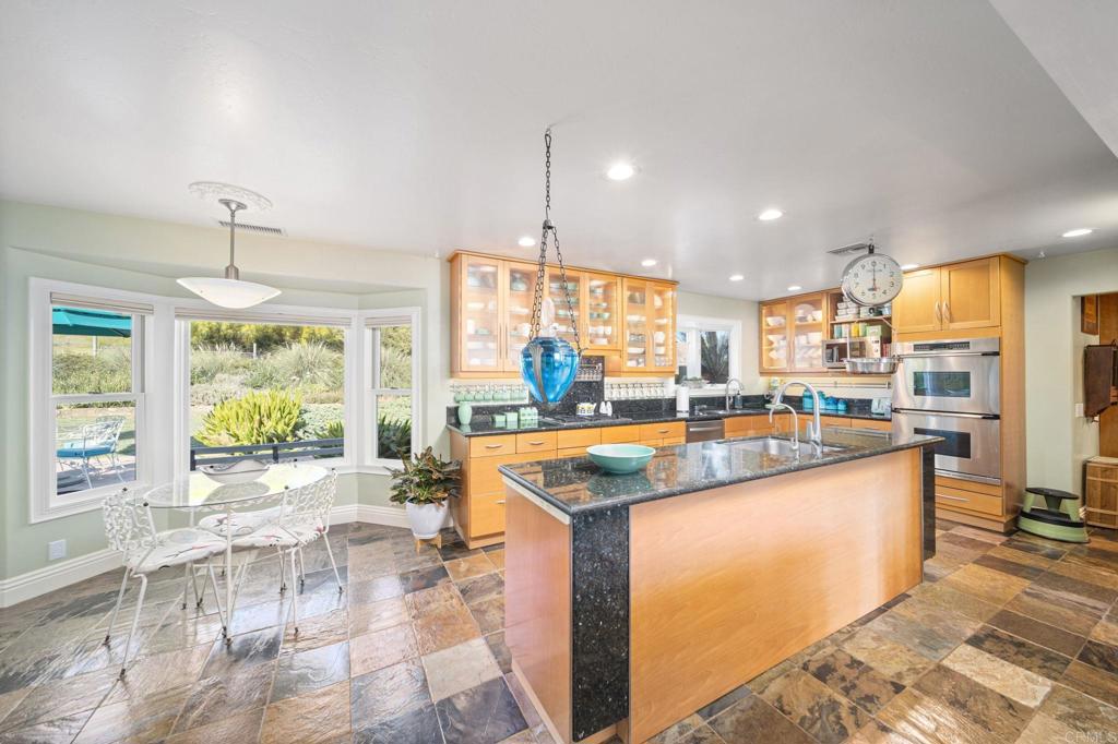 29460 Twain Valley Center, CA 92082 - Photo 39 of 75 a kitchen with stainless steel appliances granite countertop a stove and a view of living room