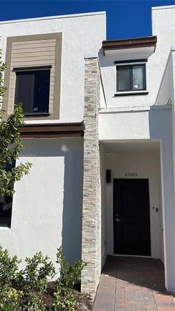 a front view of a house with plants