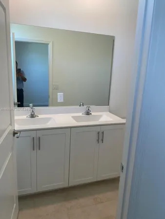 a bathroom with a sink vanity and a mirror