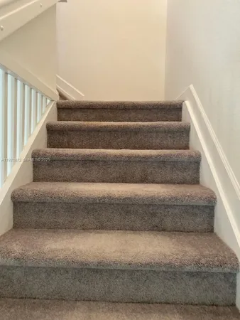 a view of staircase with white walls