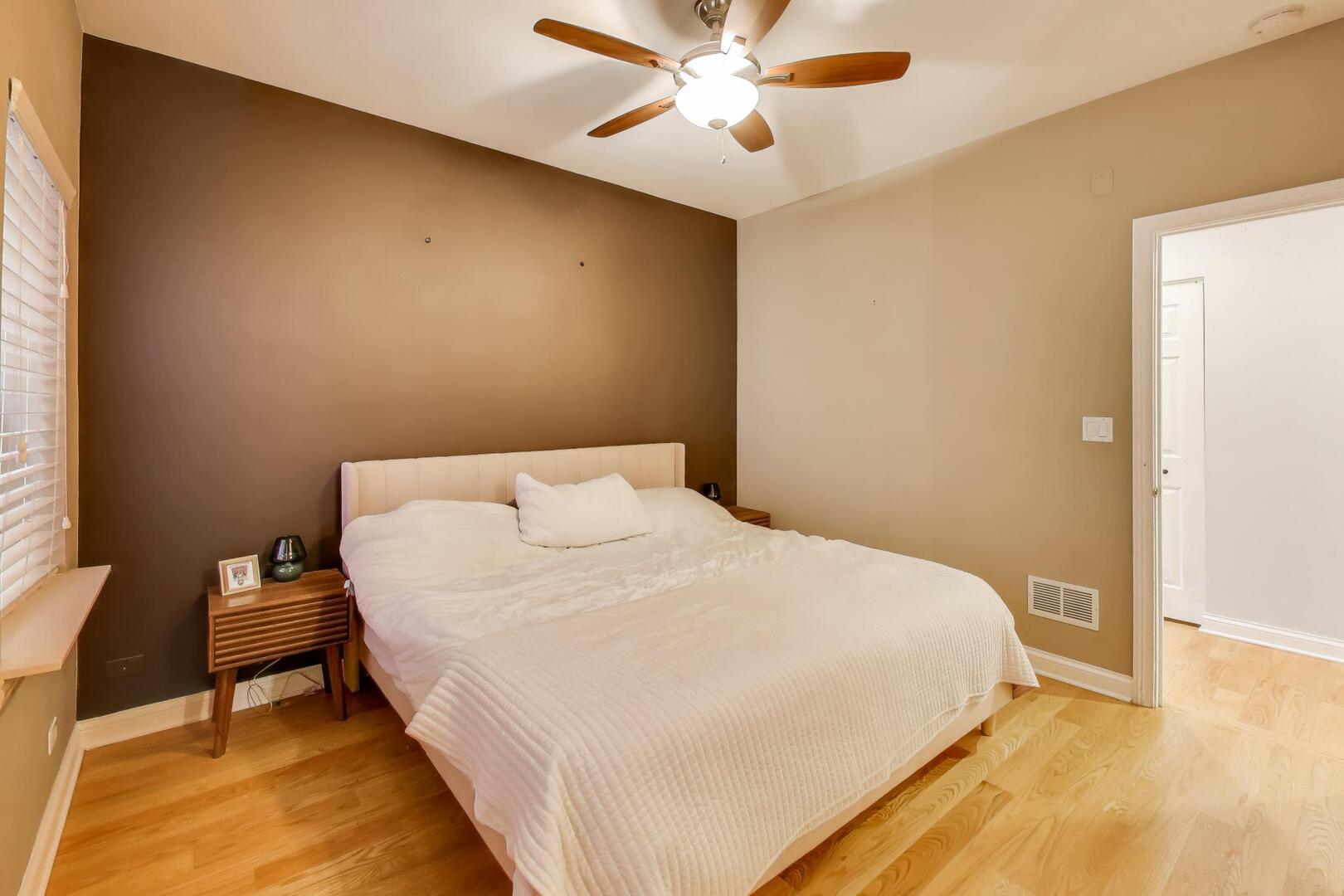 2537 North Hamlin Avenue, Unit 1S Chicago, IL 60647 - Photo 12 of 22 a bedroom with a bed and a chandelier