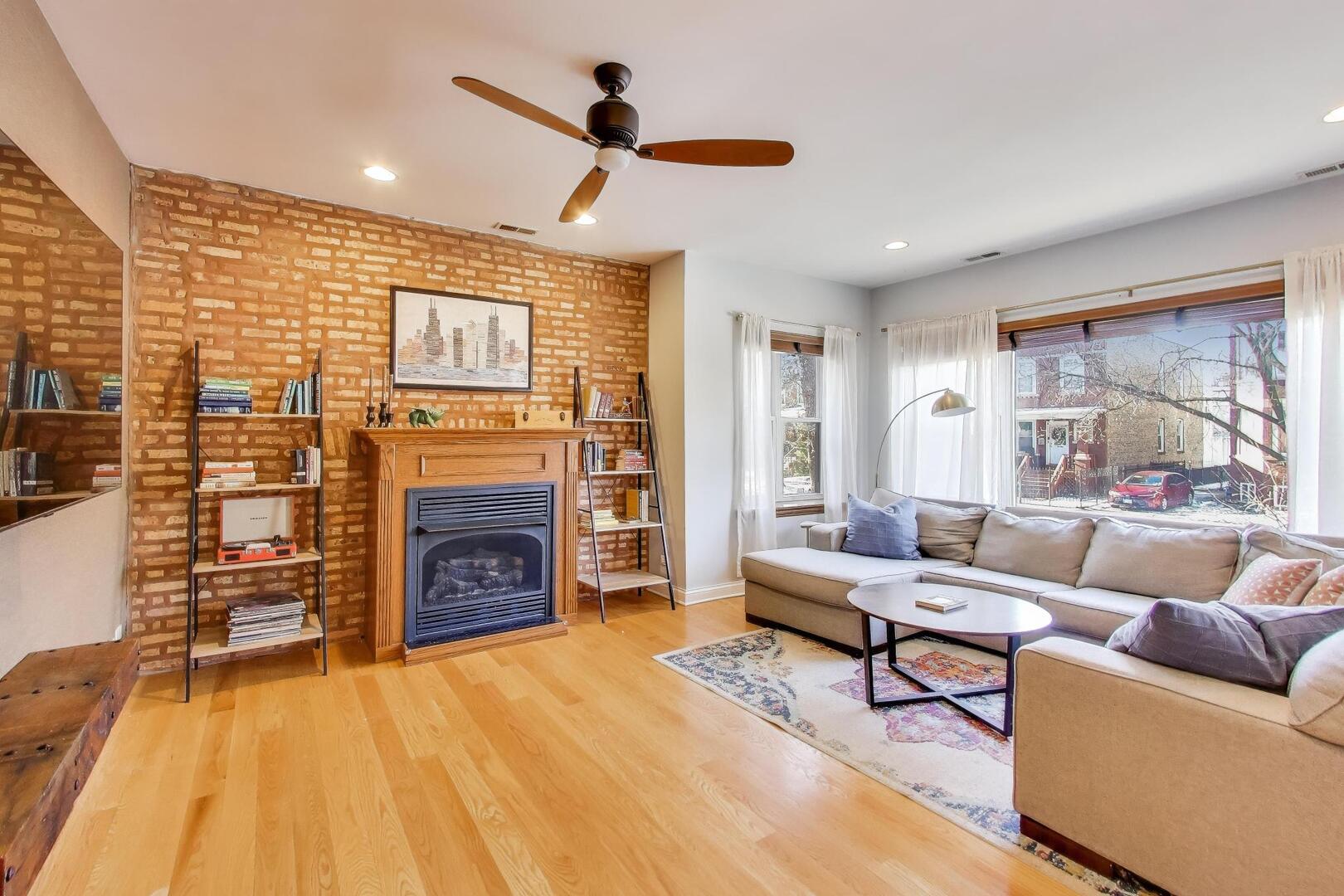 2537 North Hamlin Avenue, Unit 1S Chicago, IL 60647 - Photo 4 of 22 a living room with furniture and a fireplace