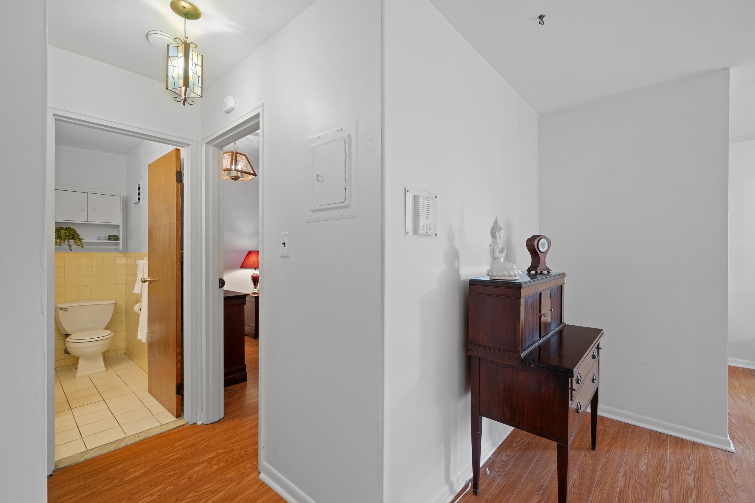 56 68th Street, Unit 8 Guttenberg, NJ 07093 - Photo 11 of 27 a view of a hallway to a livingroom and a dining room with furniture