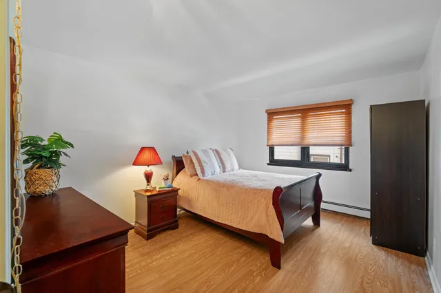 a living room with a bed furniture and a potted plant