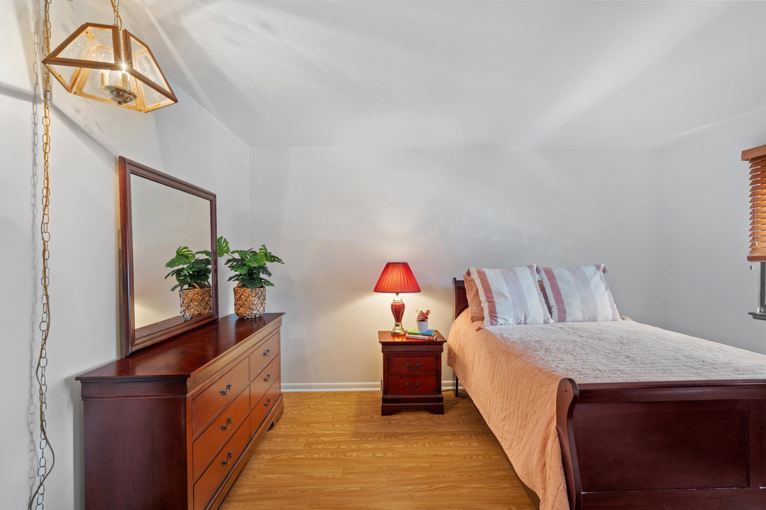 56 68th Street, Unit 8 Guttenberg, NJ 07093 - Photo 15 of 27 a bed room with a bed and a potted plant