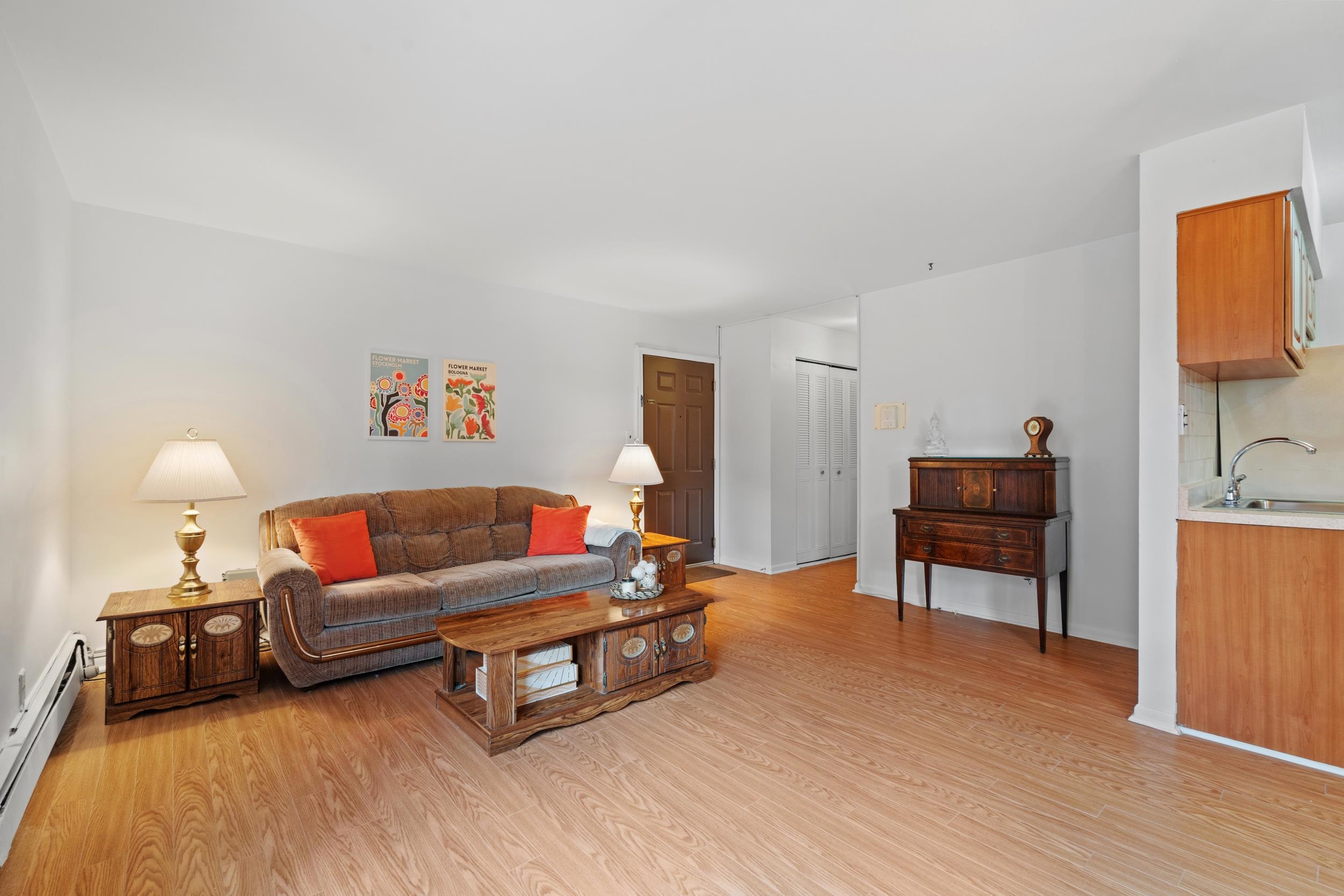 56 68th Street, Unit 8 Guttenberg, NJ 07093 - Photo 2 of 27 a living room with furniture and a wooden floor