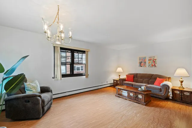 a living room with furniture and a chandelier