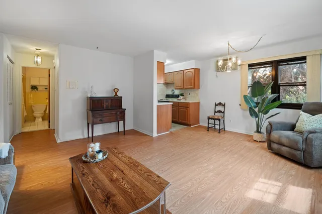 a living room with furniture a window and a flat screen tv