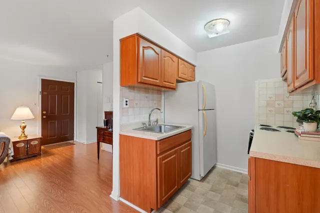 a kitchen with stainless steel appliances granite countertop a sink stove and a refrigerator