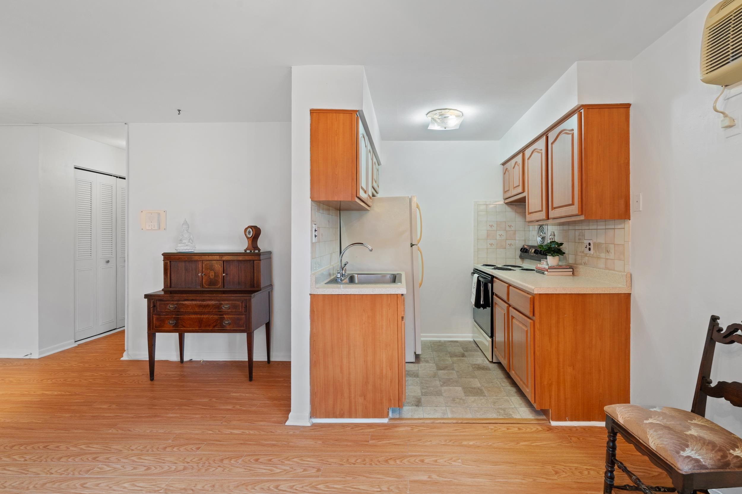 56 68th Street, Unit 8 Guttenberg, NJ 07093 - Photo 9 of 27 a living room with furniture and a wooden floor
