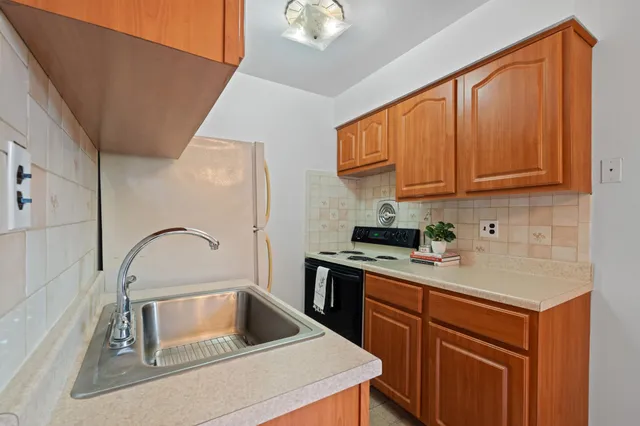 a kitchen with a sink cabinets and appliances