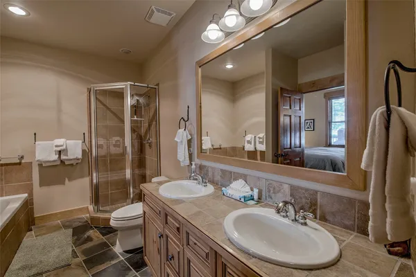 a bathroom with a sink toilet and shower