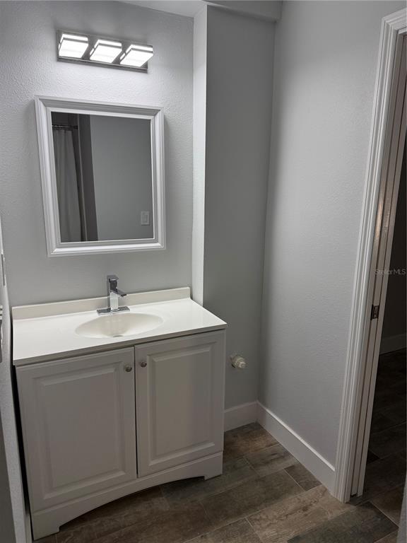 1209 1st Street Indian Rocks Beach, FL 33785 - Photo 6 of 8 a bathroom with a sink and a mirror