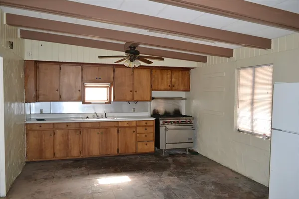 a kitchen with stainless steel appliances a sink stove and cabinets