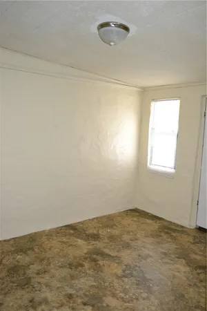 an empty room with a empty space and a window