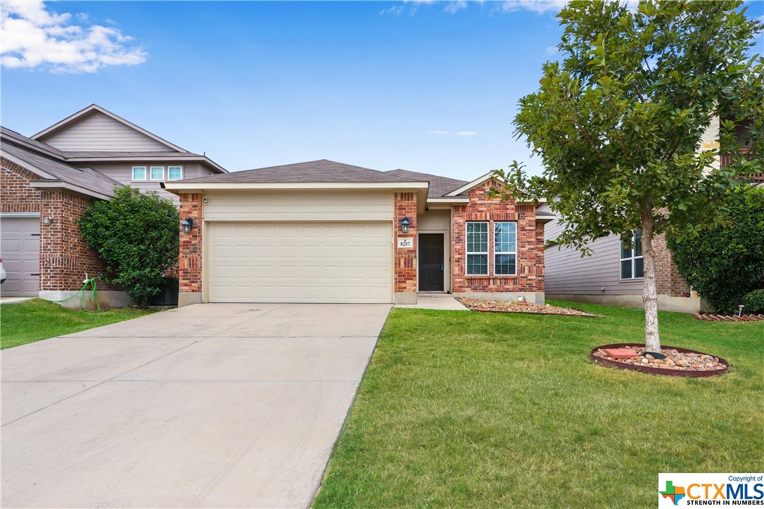 8257 Robin Gate Schertz, TX 78154 - Photo 1 of 1 a front view of a house with a yard and garage
