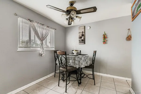 a view of a dining room with furniture and a chandelier fan