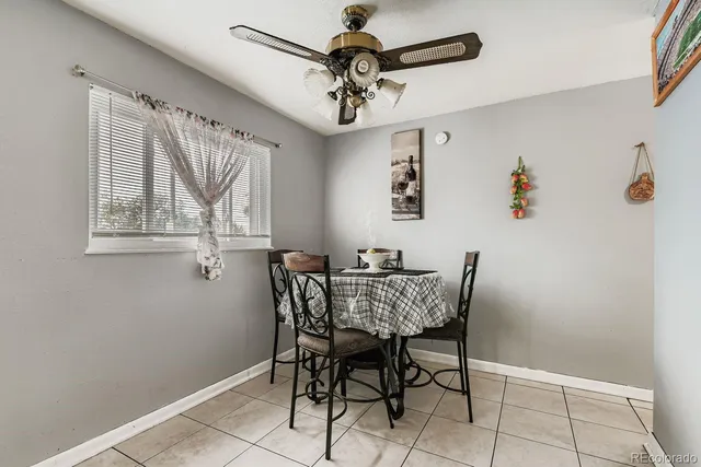 a view of a dining room with furniture and a chandelier fan