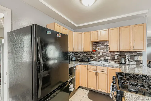 a kitchen with stainless steel appliances a stove a refrigerator and a sink