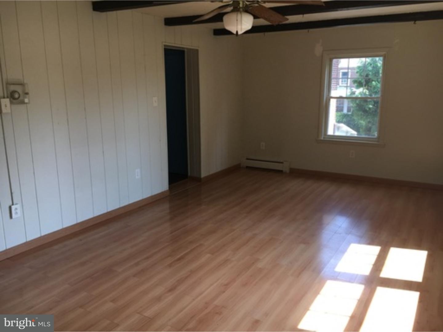 232 Carroll Street Reading, PA 19611 - Photo 6 of 9 an empty room with wooden floor and windows