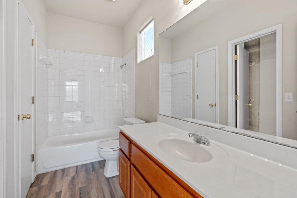 7502 Lazy Creek Drive, Unit B Austin, TX 78724 - Photo 12 of 24 a bathroom with a granite countertop sink a toilet and shower