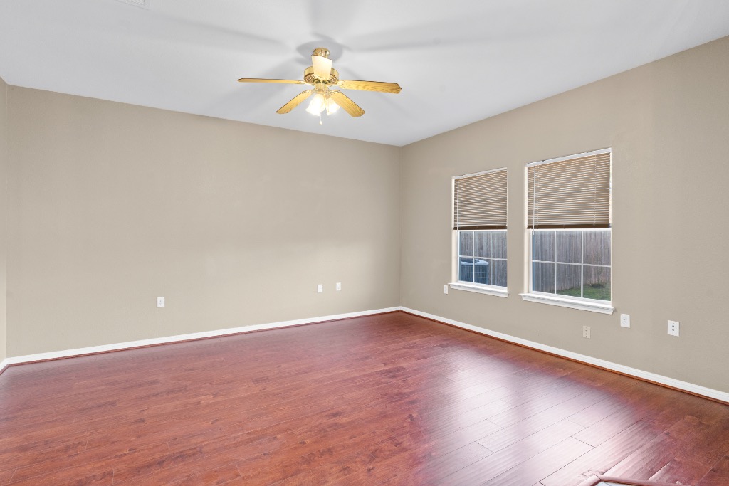 7502 Lazy Creek Drive, Unit B Austin, TX 78724 - Photo 9 of 24 an empty room with wooden floor and windows