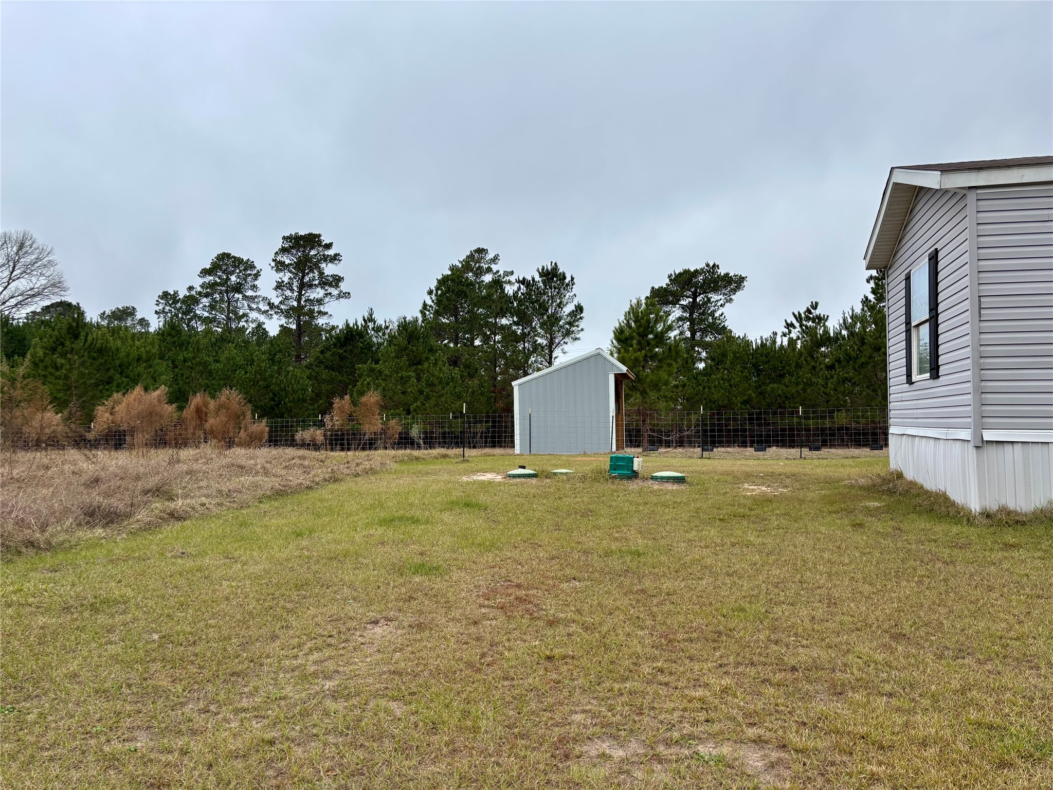 707 Bill Rasbeary Road Groveton, TX 75845 - Photo 19 of 48 a swimming pool with wooden fence