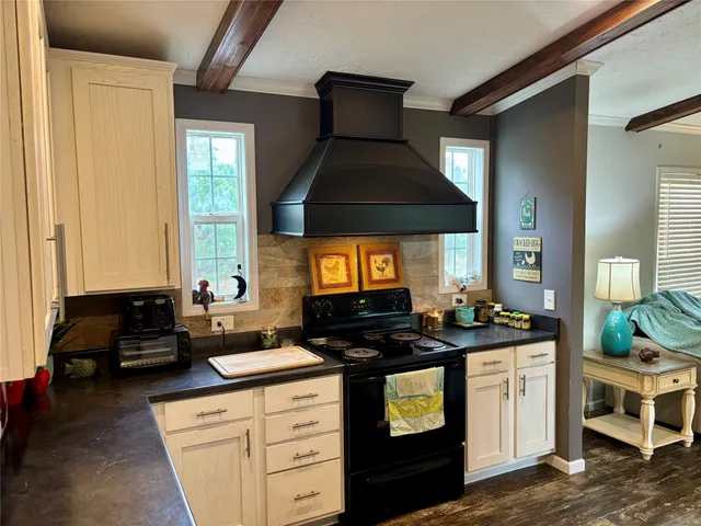 a kitchen with stainless steel appliances granite countertop a sink a stove and cabinets