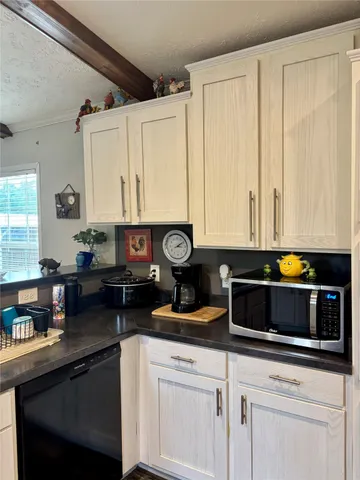 a kitchen with stainless steel appliances a refrigerator and cabinets