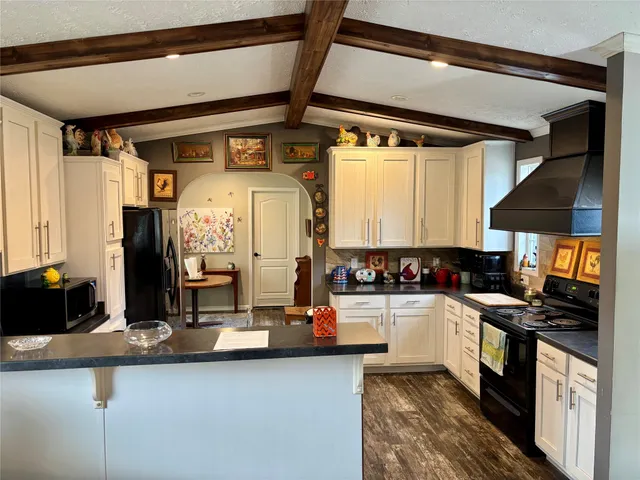 a kitchen with a refrigerator and a stove