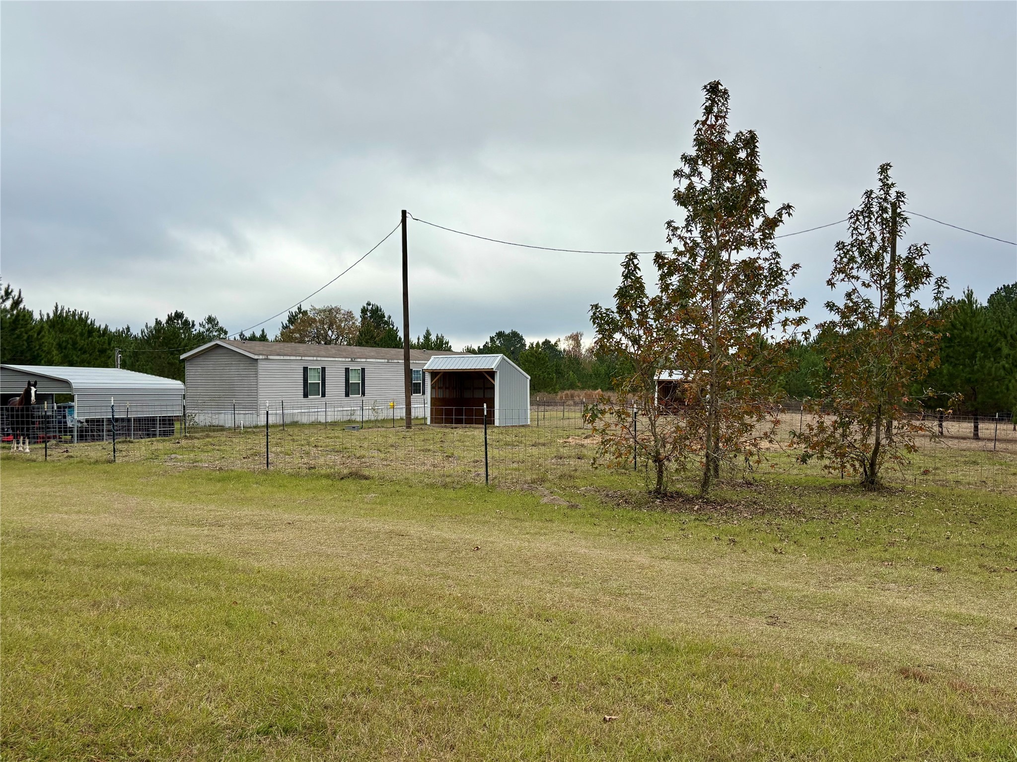 707 Bill Rasbeary Road Groveton, TX 75845 - Photo 5 of 48 a swimming pool with outdoor seating and yard