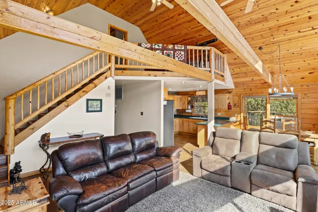 a view of a patio with couches chairs and wooden floor