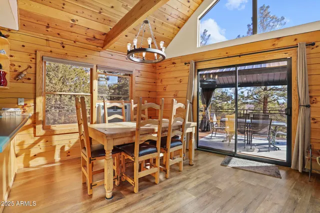 a view of a dining room with furniture wooden floor and chandelier